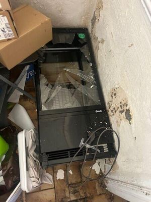 a television sitting on the floor in the corner of a room