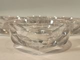 three clear glass bowls sitting on top of a white table