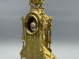 a gold clock that is sitting on a table