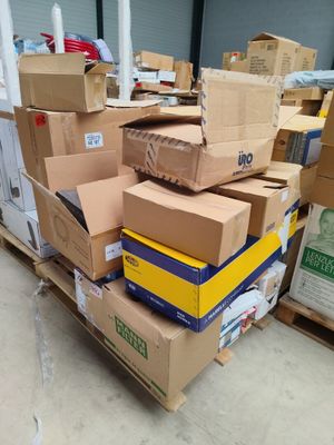 many boxes stacked on top of each other in a warehouse