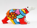 brightly colored ceramic polar bear figurine on a white background