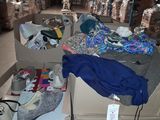 many boxes of clothing on the floor in a warehouse