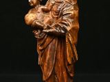 a statue of a woman holding a child in her arms