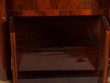 a wooden cabinet with a mirror on top of it