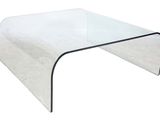 a clear glass coffee table with a curved glass top