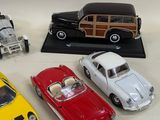 several toy cars are lined up in a row on a white surface