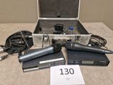 three microphones sitting in a case on a table