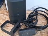 a black speaker and a charger sitting on a table