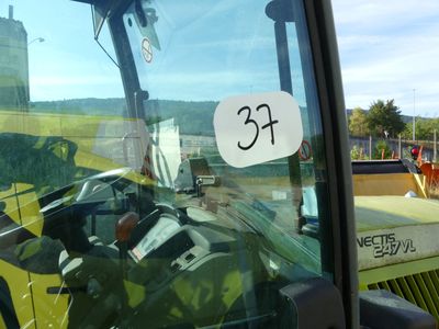 a picture of a tractor that is parked in the grass