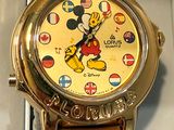mickey mouse watch in a box with a brown leather strap