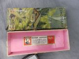 a pink box with a picture of a house inside of it