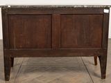 a wooden cabinet with a marble top on a wooden floor