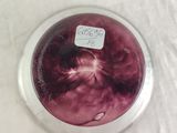 a glass bowl with a red substance in it on a table