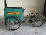 a bicycle with a cart attached to it in a garage