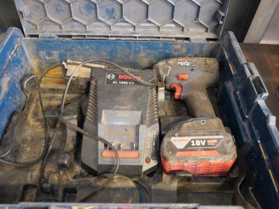 a tool box filled with tools that include a drill, a hammer, and a charger