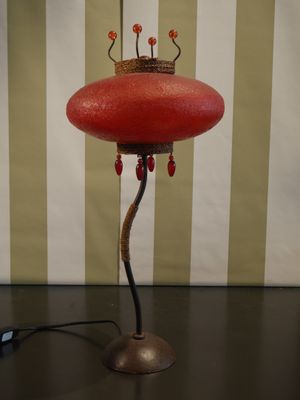 a red lamp that is sitting on a table