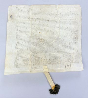 an old piece of paper with a burnt piece of wood sticking out of it
