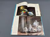 an open book with a picture of a space station on it