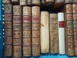 many old books in a blue box on a shelf