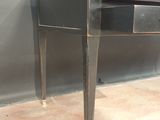 a black desk with two drawers on it in a room