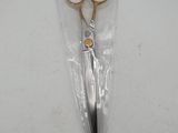 a pair of scissors in a plastic bag on a table