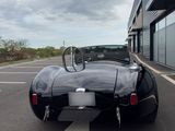an image of a black sports car parked in a parking lot