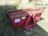 a red dumpster sitting in the middle of a field