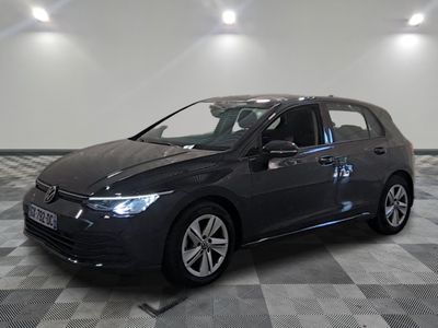 the volkswagen golf is parked in a large room with a checkered floor