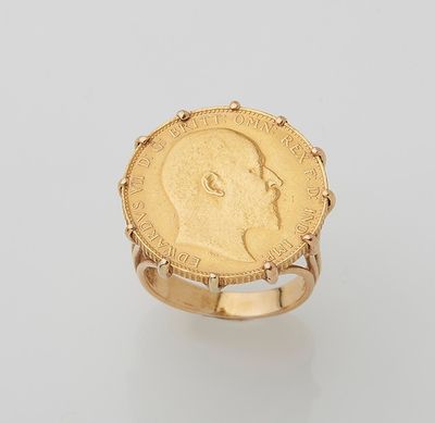 a gold coin ring with a profile of a man