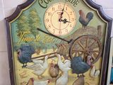 a clock that has a picture of chickens on it