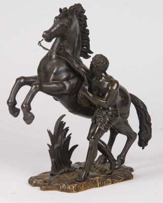 statue of a man on a horse with a man on the back of it