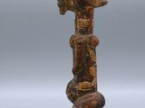 a close up of a wooden sculpture with a bird on top of it