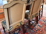 two chairs that are sitting on a rug in a room