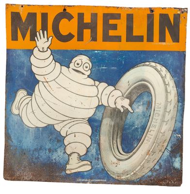 une photo d'une enseigne « Michel Michel Pneus » accrochée à un mur