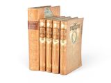 three books are stacked on top of each other on a white surface