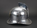 a silver helmet that is on display on a table
