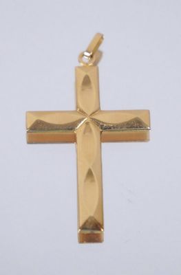 a close up of a gold cross on a white background