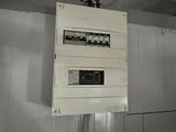 a white electrical box hanging from the ceiling in a room
