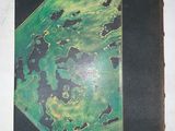 a green and black book on a white surface