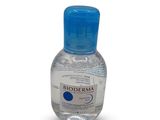 the bottle of hand sanitizer is sitting on a white surface