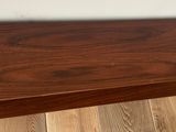 a wooden table with a wooden top on a hard wood floor