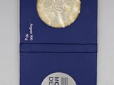 a close up of a blue box with a gold coin on it