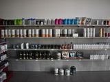 many bottles and cans on the shelves in the store