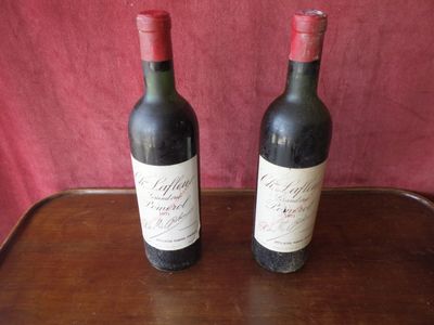 two bottles of wine that are sitting on a table