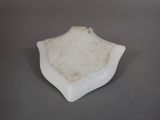 a small white bowl on a table with a gray background