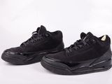 a pair of black sneakers with black soles on a white background