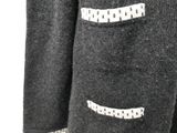 a close up of a black jacket with white polka dots on it