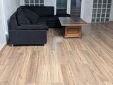 a living room with a black couch and a coffee table