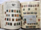 an open book with stamps on it on a table