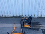 an image of a small air compressor sitting on the ground